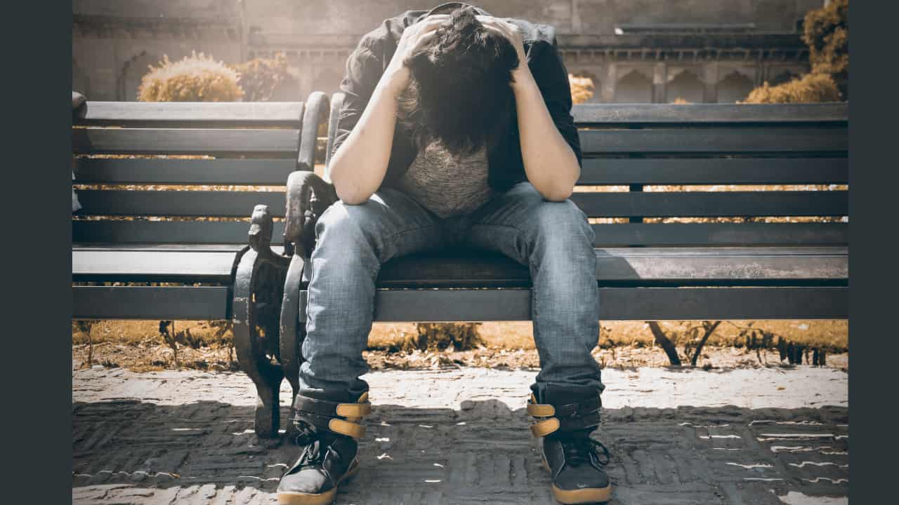 sad man holding his head